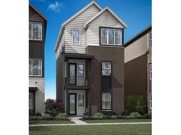 Modern two-story home featuring a blend of brick and siding, complemented by a small front yard and a compact balcony at 1727 W 166Th Ave, Broomfield, CO 80023