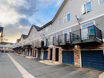 Charming townhomes featuring brick garages and balconies, creating an inviting street appeal at 2951 W Riverwalk Cir # N, Littleton, CO 80123