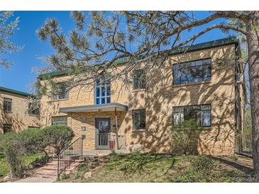 Brick apartment building with mature trees and landscaping in front at 1182 N Clermont St # 101, Denver, CO 80220