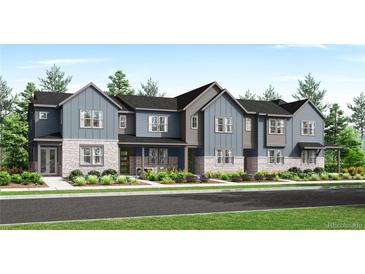 Charming townhome with stone accents and colorful landscaping for great curb appeal at 2969 E 103Rd Dr, Thornton, CO 80229