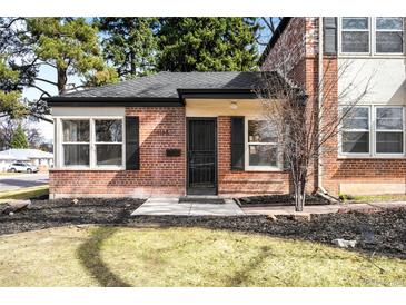 Charming brick home featuring professionally landscaped front yard and stylish black shutters at 1168 Kearney St, Denver, CO 80220