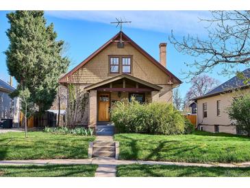 Charming home featuring a well-manicured lawn, brick accents, and inviting front porch at 3051 W 39Th Ave, Denver, CO 80211