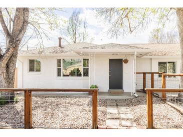 Charming home with a white brick facade, complemented by a stylish front entrance and inviting walkway at 4420 W 27Th Ave, Denver, CO 80212