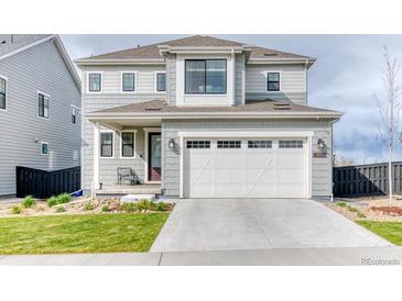 Charming two-story home featuring a gray exterior, well-maintained landscaping, and an attached two-car garage at 8939 Bellsong Cir, Littleton, CO 80125