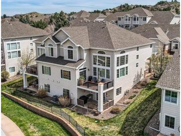 Stunning two-story home with a spacious deck, manicured landscaping, and beautiful architectural details at 3109 Newport Cir, Castle Rock, CO 80104