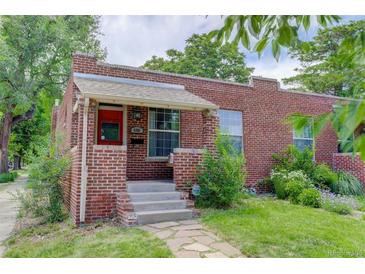 Charming brick home with a cozy front porch, concrete steps, and well-maintained landscaping at 4301 Zuni St, Denver, CO 80211
