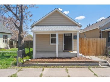 Charming exterior showcasing the tan siding, covered porch, and fresh landscaping at 4636 Leaf Ct, Denver, CO 80216