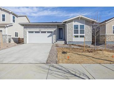 Charming single-story home featuring stone accents, a two-car garage, and a concrete driveway at 24719 E 39Th Ave, Aurora, CO 80019