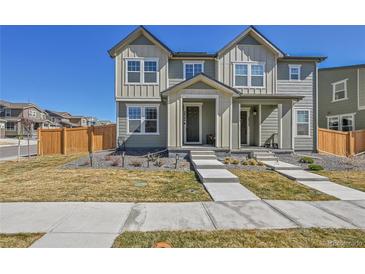 Charming townhouse with well-maintained front yard and inviting entryway steps at 28304 E 6Th Pl, Watkins, CO 80137