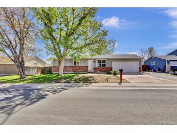 Charming single-story home featuring a brick facade and mature landscaping at 6434 S Dudley Way, Littleton, CO 80123
