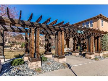 Beautiful wooden pergola over the entry walkway of the house at 10213 Bluffmont Dr, Lone Tree, CO 80124
