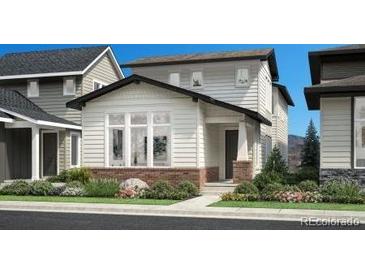 Charming two-story home featuring a brick facade and a well-manicured lawn at 716 Belay St, Erie, CO 80516