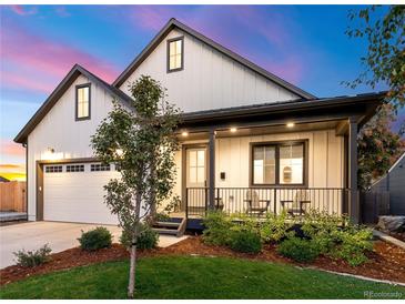 Craftsman style home with white siding, landscaping, and a covered porch at 3260 S Corona St, Englewood, CO 80113