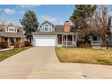 Charming two-story home with a well-maintained lawn and a cozy front porch in a suburban neighborhood at 19257 E Legend Ave, Parker, CO 80134