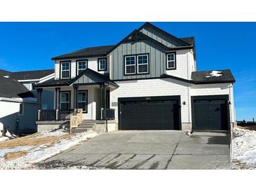 Two-story house with gray and white siding, a two-car garage, and a front porch at 39420 Congress Ln, Elizabeth, CO 80107