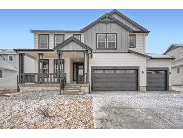 Charming two-story home with a covered front porch and an attached two-car garage at 39420 Congress Ln, Elizabeth, CO 80107