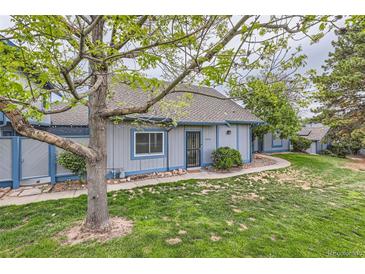 Charming home featuring a well-maintained lawn, mature tree, and inviting exterior at 2488 S Victor St # E, Aurora, CO 80014