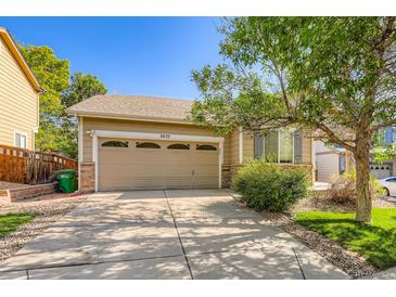 Charming home featuring a two-car garage, well-maintained lawn, and mature trees in a pleasant neighborhood at 5037 Pelican St, Brighton, CO 80601