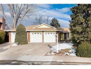 Brick ranch home with 3-car garage, landscaped yard, and partially visible snow at 6926 S Saulsbury St, Littleton, CO 80128