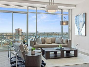 Bright living room featuring floor to ceiling windows with great views, stylish furniture and modern decor at 2001 Lincoln St # 1822, Denver, CO 80202
