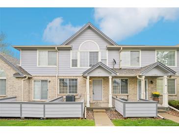 Charming townhouse with a brick and siding exterior, complemented by a well-maintained front lawn at 1259 W 112Th Ave # B, Denver, CO 80234