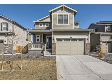 Charming two-story home with a two car garage, a covered porch and beautiful stone accents at 13261 E 110Th Pl, Commerce City, CO 80022