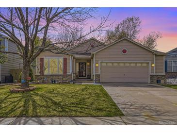 Charming single-Gathering home with well-maintained lawn, two-car garage, and lovely landscaping details at 2556 E 131St Pl, Thornton, CO 80241