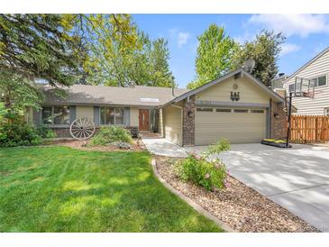 Charming ranch-style home with a well-manicured lawn, mature trees, and a two-car garage at 5050 W 102Nd Ave, Westminster, CO 80031