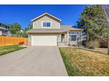 Charming two-story home featuring a two-car garage and well-maintained front yard at 7835 Canvasback Cir, Littleton, CO 80125