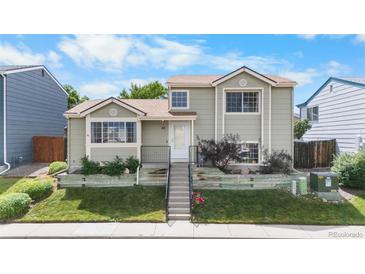 Charming two-story home with a well-maintained lawn and landscaped garden, enhanced by a neatly stepped walkway at 113 Rockaway Ave, Castle Rock, CO 80104