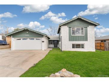 Charming exterior view of a two-story home with a well-maintained lawn and attached garage at 6190 Garrison St, Arvada, CO 80004