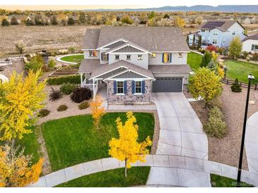 Beautiful two-story home with lush landscaping and a welcoming front porch at 2258 Front Range Rd, Erie, CO 80516