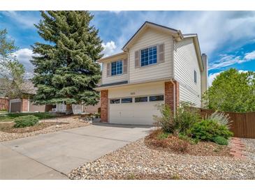Charming two-story home featuring a two-car garage, mature tree, and well-maintained landscaping at 7072 Palisade Dr, Highlands Ranch, CO 80130