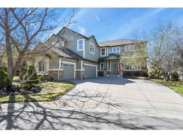 Charming two-story home with three-car garage and well-maintained lawn under a blue sky at 22386 E Arbor Pl, Aurora, CO 80016