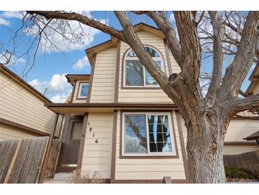 Charming two-story home with neutral siding, brown trim, and a large tree in the front yard at 1816 S Pagosa Way # 5, Aurora, CO 80017