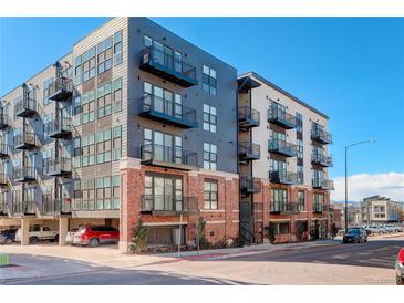 Modern multi-story apartment building with brick facade and private balconies at 3500 S Corona St # 205, Englewood, CO 80113