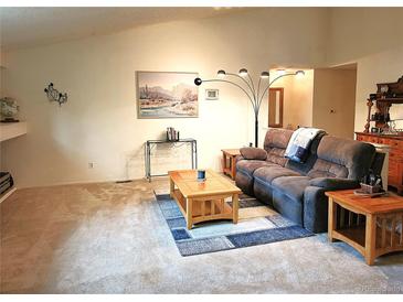 Spacious living room featuring plush carpeting, comfortable seating, and natural light at 5860 W 115Th Ave, Westminster, CO 80020