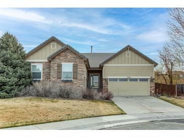 Charming single-story home featuring stone and siding accents, a two-car garage, and well-maintained landscaping at 13744 Columbine St, Thornton, CO 80602