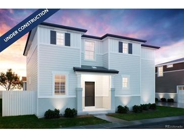 Charming two-story home with white siding, black shutters, and landscaped front yard at 22382 E 39Th Ave, Aurora, CO 80019