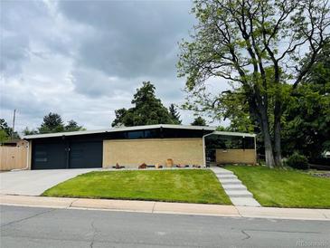Charming single-story home with a well-maintained lawn and a modern design at 6068 S Clayton St, Centennial, CO 80121