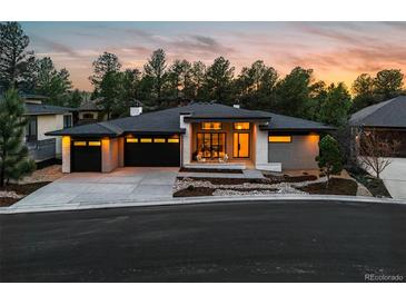 Stunning exterior view of a modern home with a three-car garage and beautiful landscaping at 2580 Saddleback Dr, Castle Rock, CO 80104