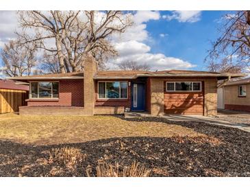 Charming brick home with large windows and manicured lawn, creating a welcoming curb appeal at 1370 Upham St, Lakewood, CO 80214