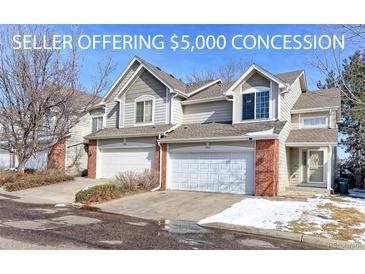 Charming townhouse with a two-car garage, brick accents, and well-maintained landscaping in a desirable neighborhood at 13068 Harrison Dr, Thornton, CO 80241
