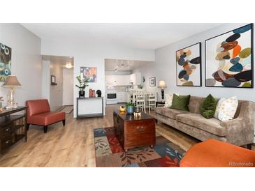 Open living room with wood floors, modern decor, and bright natural light at 3082 S Wheeling Way # 410, Aurora, CO 80014