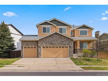 Charming two-story home with a stone facade and three-car garage at 1936 Alpine Dr, Erie, CO 80516