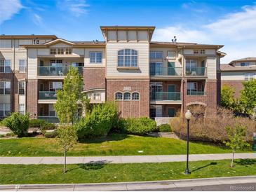 Stunning multi-story condo building with brick and neutral siding, balconies, and well-maintained landscaping at 3865 S Dayton St # 105, Aurora, CO 80014