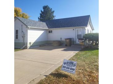 Charming single-story home with a well-maintained front yard and a concrete driveway at 254 Donna St, Fort Lupton, CO 80621