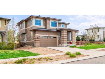 Inviting two-story home boasting an attached two-car garage, brick accents, and a well-kept lawn at 9570 Kendrick Way, Arvada, CO 80007