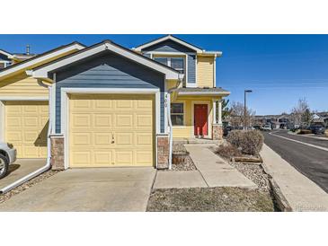 Charming exterior of a two-story home featuring a front-facing garage and a red front door at 400 Smith Cir, Erie, CO 80516