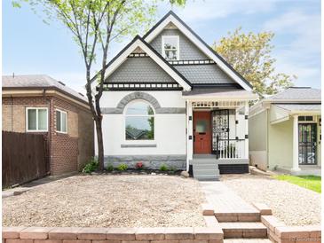 Charming two-story home showcasing a picturesque exterior with unique architectural details and landscaped front yard at 230 E Ellsworth Ave, Denver, CO 80209